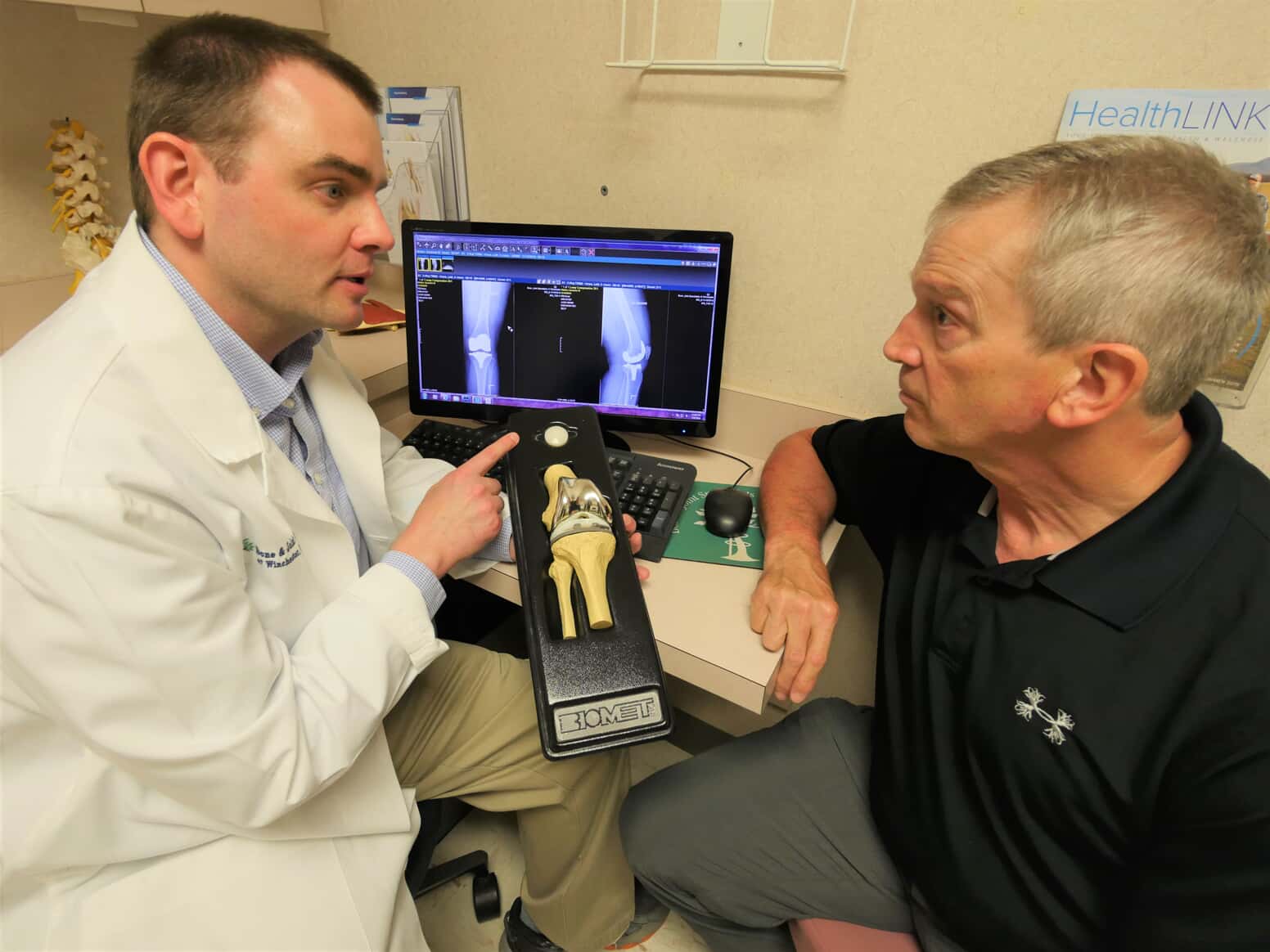 photo of Dr. Courtney discussing knee replacement with a patient