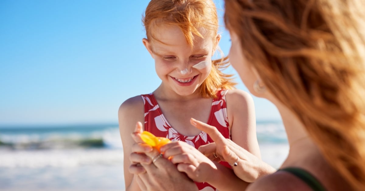 woman and girl on beach;