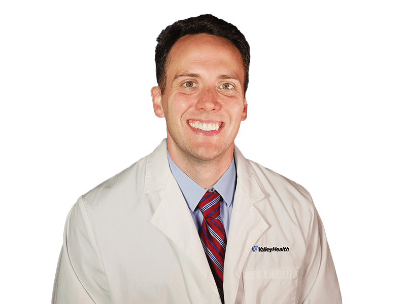Photo of Dr. Volkema with white coat