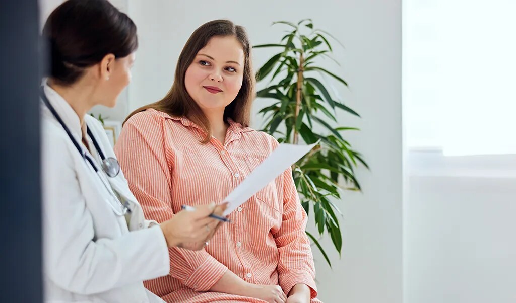 Female doctor talking to female patient