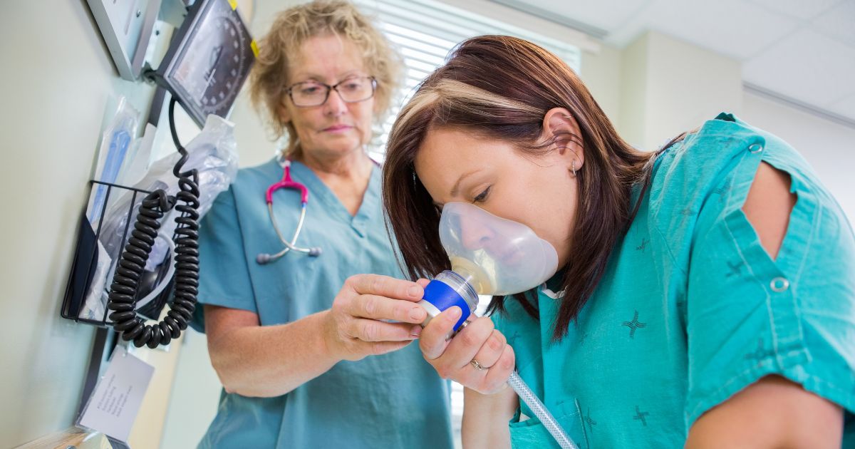 woman breathing through air mask