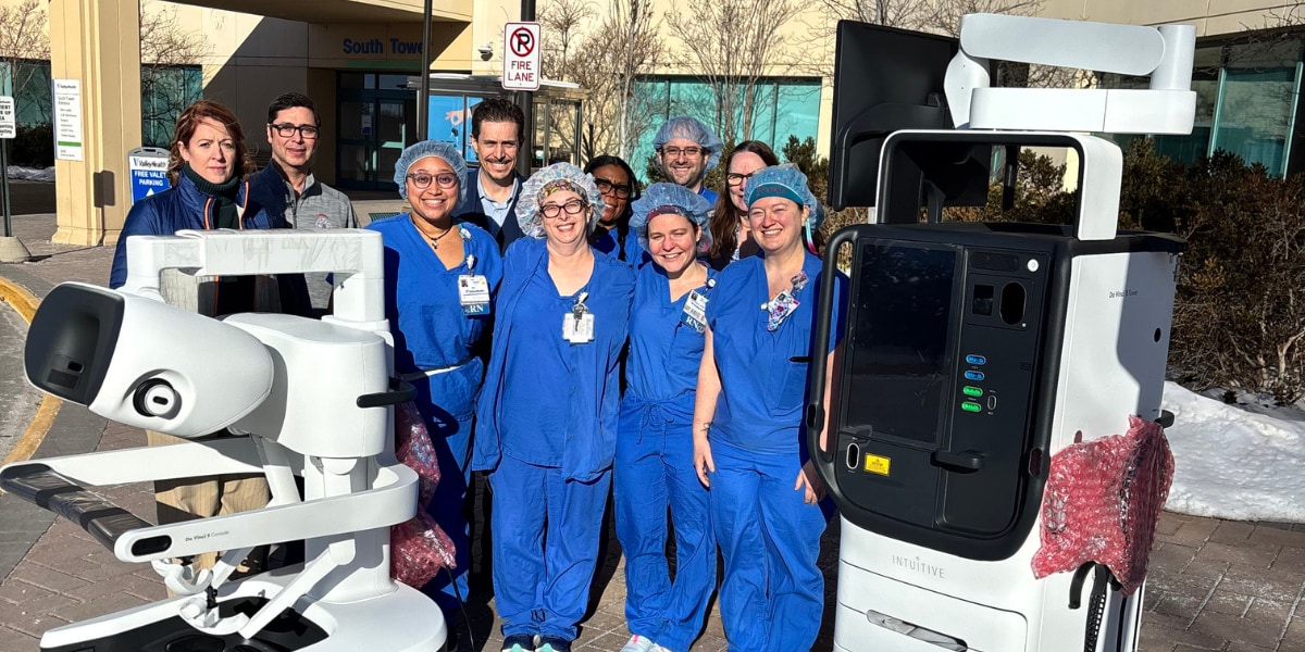 Careteam posing with da Vinci 5 robot outside Winchester Medical Center for 10,000 robotic cases completed