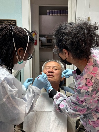 dental professionals caring for man