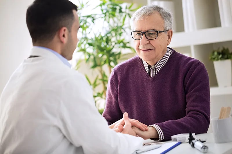 doctor talking to elderly man