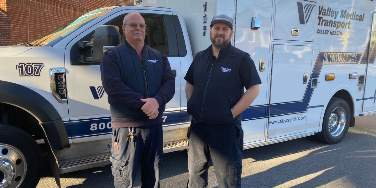 two men next to ambulance