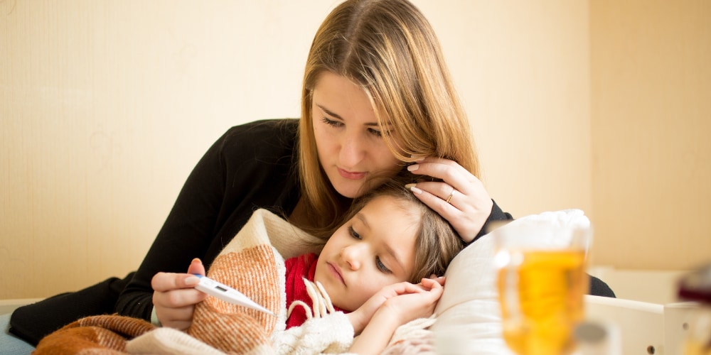 Mother taking temperature of child