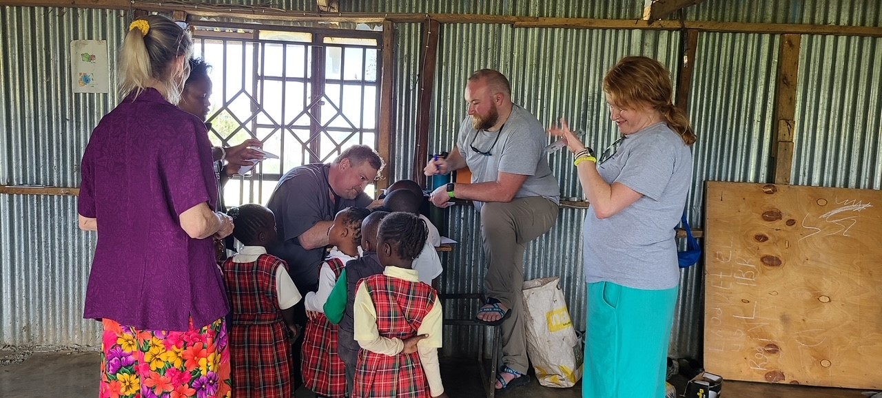 Dr. Lee African clinic ear exams with kids