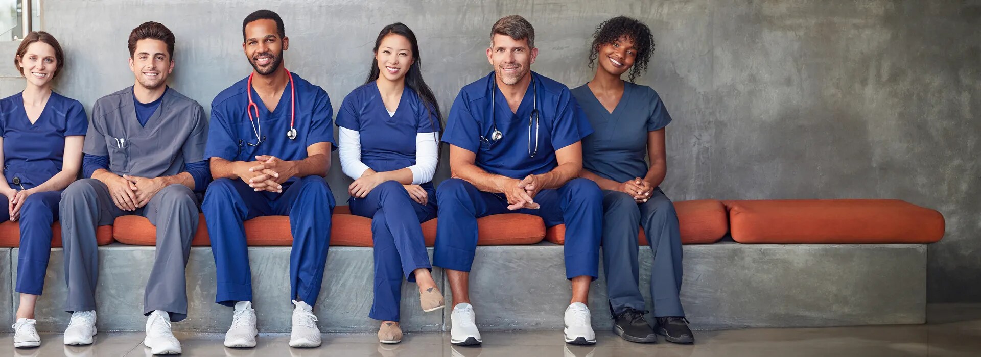 Group of healthcare workers sitting on a bench