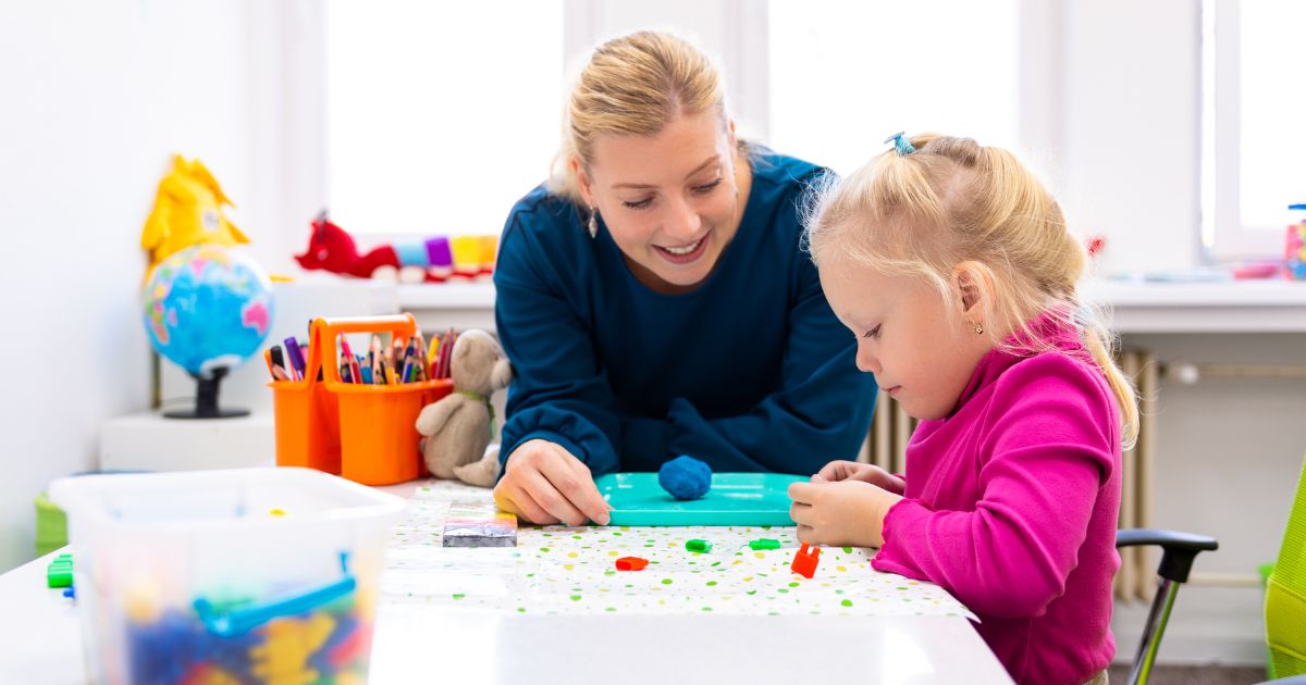 woman with girl working on crafts