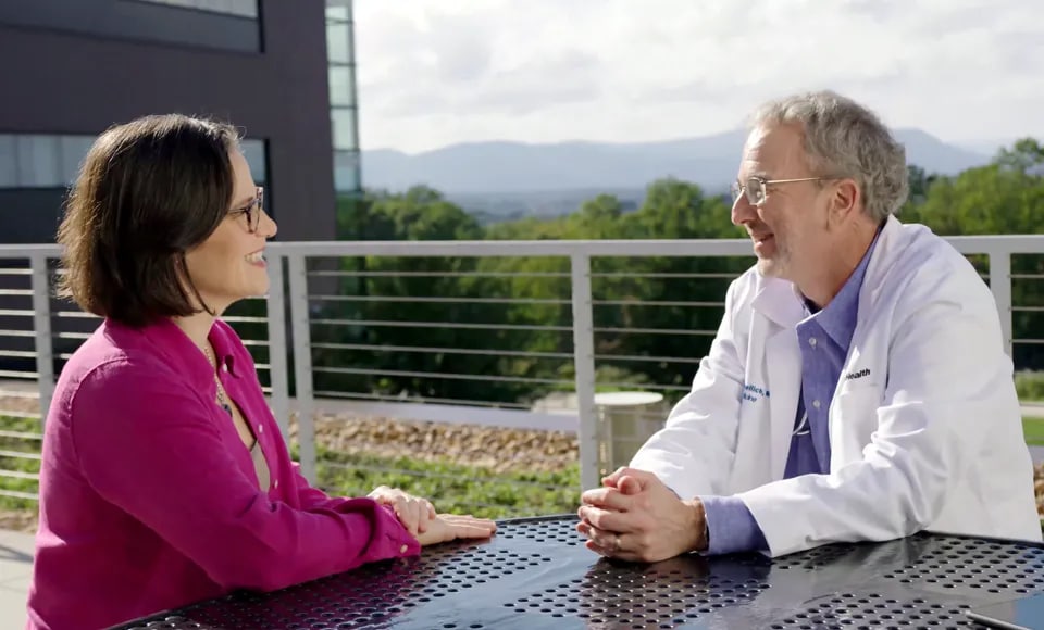 Two co-workers talking outside