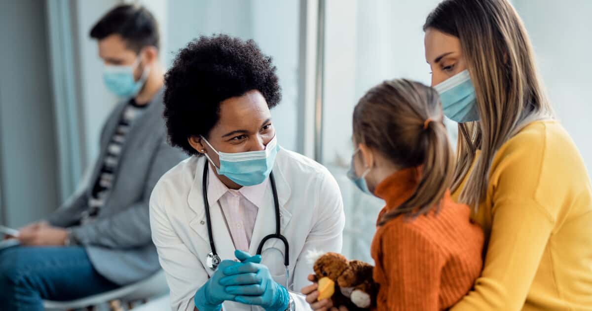 Doctor talking to mother and daughter