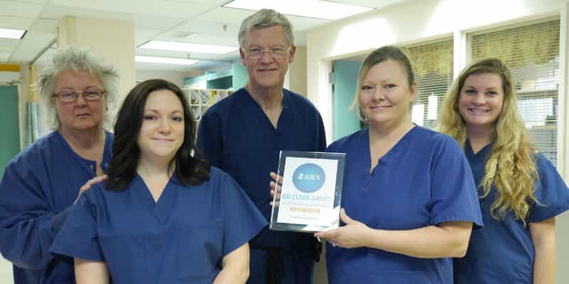 Hospital staff members  showing an award