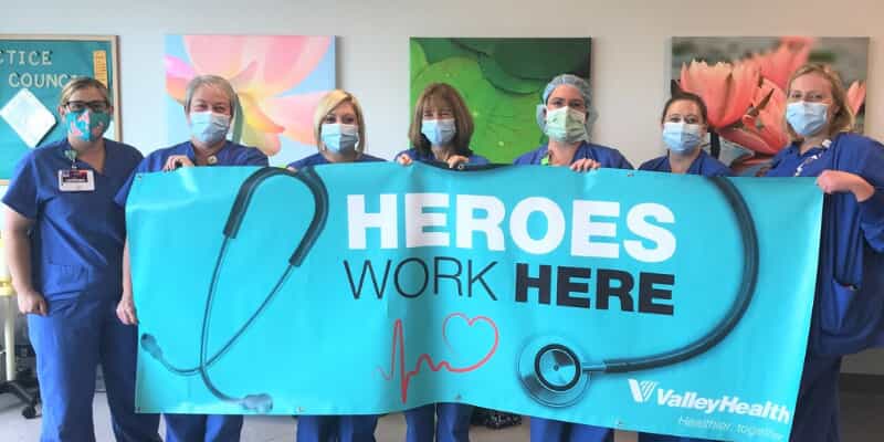 Hospital staff holding a banner