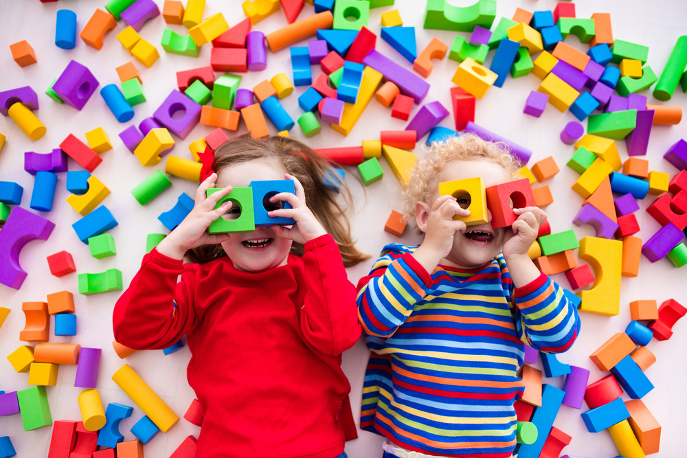 kids looking through blocks