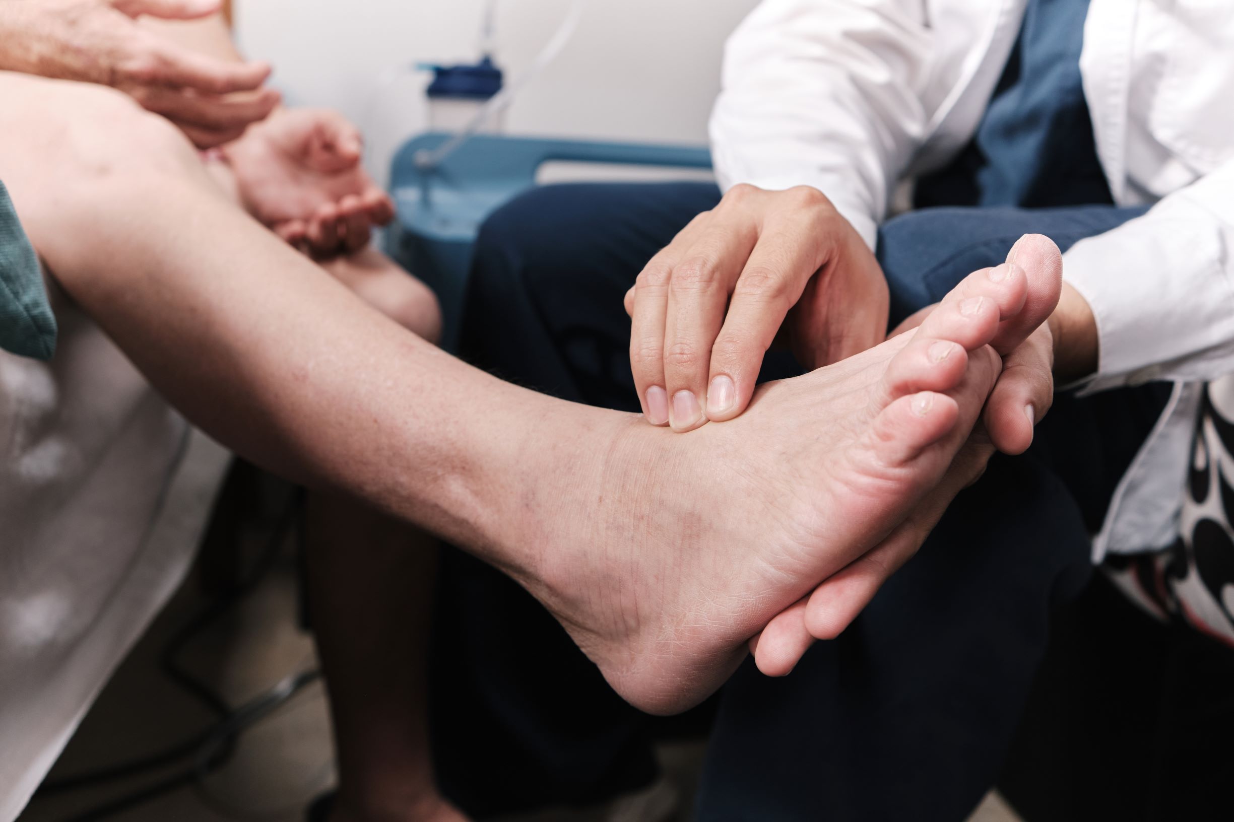doctor checking the foot of patient