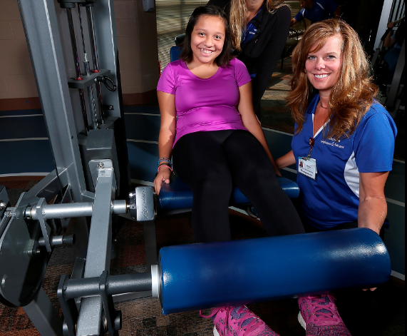 Photo of girl using leg lift machine